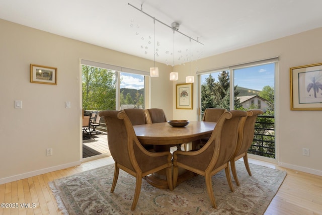 12 June Creek Rd, Edwards, CO 81632 - dining area with track lighting, light wood-style flooring, and plenty of natural light