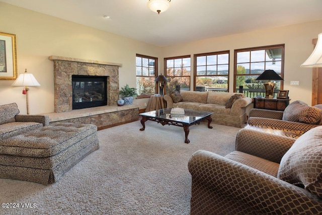 living area with carpet and a high end fireplace