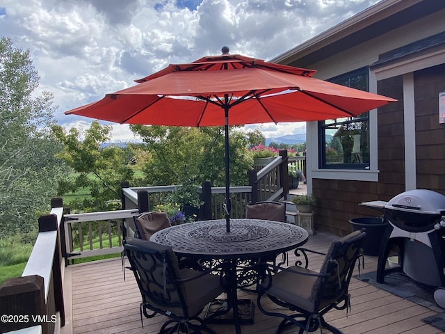 deck with grilling area and outdoor dining space