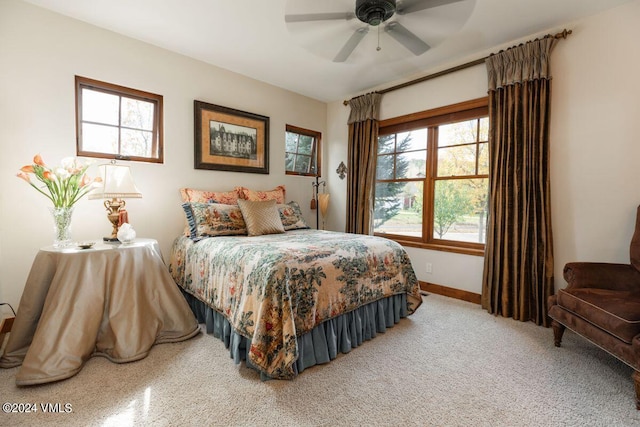 bedroom with a ceiling fan and baseboards