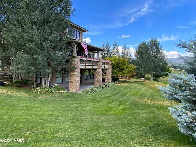 view of yard featuring a deck and a patio