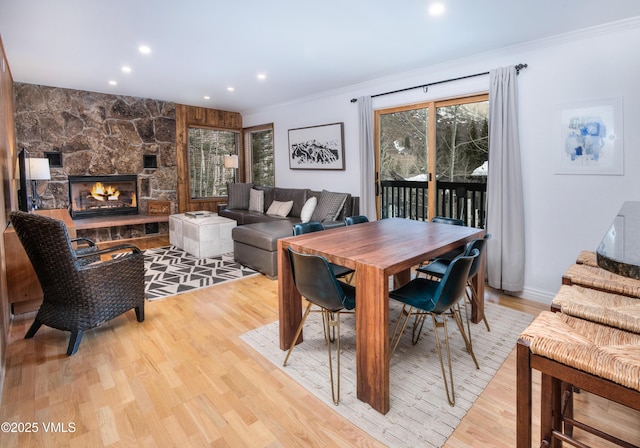4479 Timber Falls Ct Unit 2001, Vail, CO 81657 - dining space with crown molding, light wood-type flooring, a fireplace, and recessed lighting