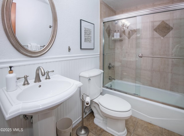 4479 Timber Falls Ct Unit 2001, Vail, CO 81657 - bathroom featuring shower / bath combination with glass door, a wainscoted wall, and tile patterned floors