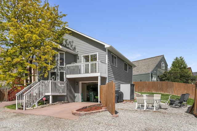 443 Porphyry Rd Unit F, Gypsum, CO 81637 - back of property with a balcony, a garage, and concrete driveway