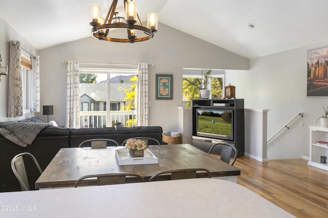 443 Porphyry Rd Unit F, Gypsum, CO 81637 - dining space with a chandelier, wood finished floors, vaulted ceiling, and baseboards