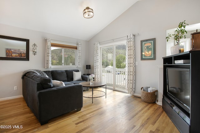 443 Porphyry Rd Unit F, Gypsum, CO 81637 - living area featuring light wood finished floors, baseboards, and high vaulted ceiling