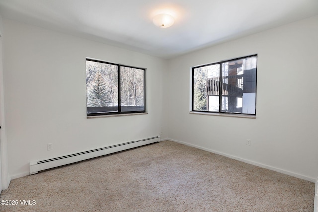 carpeted spare room with a baseboard radiator