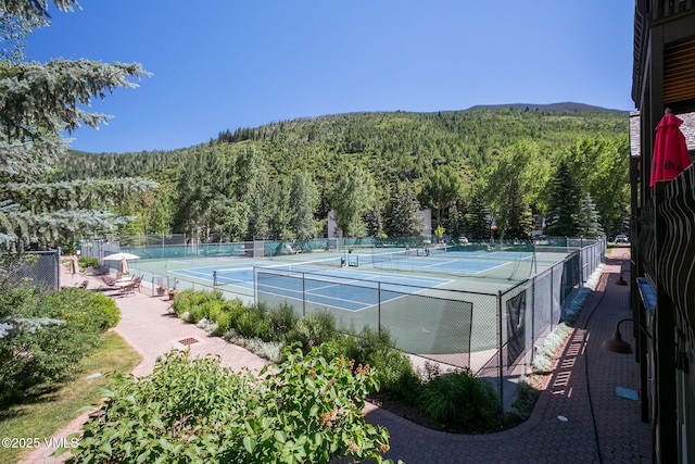 view of tennis court with a mountain view