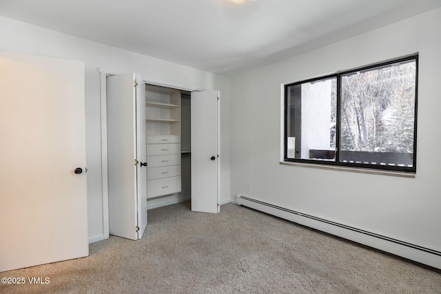 unfurnished bedroom featuring a closet and baseboard heating