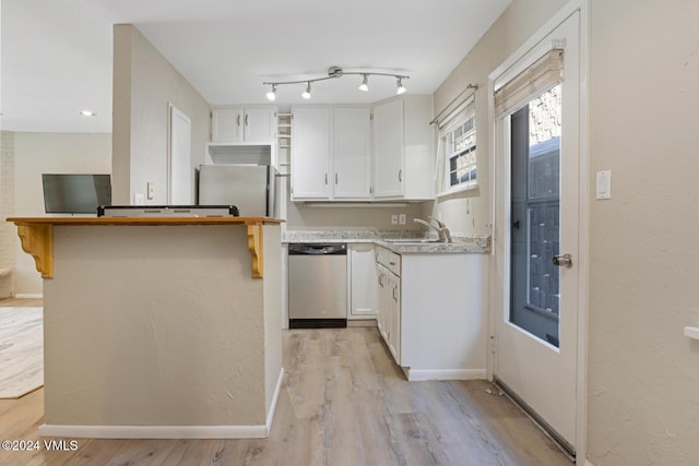 kitchen with sink, light hardwood / wood-style flooring, track lighting, dishwasher, and white cabinets