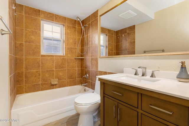 full bathroom featuring vanity, toilet, and tiled shower / bath