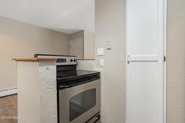 kitchen with a baseboard heating unit, stainless steel electric range, light hardwood / wood-style flooring, and white cabinets