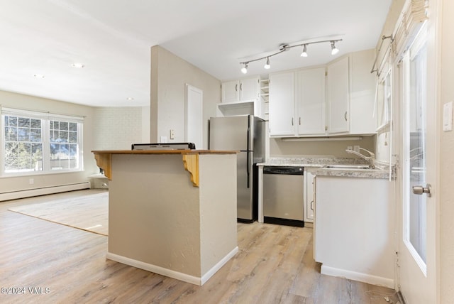 kitchen featuring appliances with stainless steel finishes, sink, white cabinets, and light hardwood / wood-style flooring