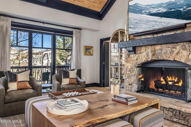 130 Daybreak Rd Unit R401, Beaver Creek, CO 81620 - living area featuring a mountain view, baseboards, high vaulted ceiling, a fireplace, and wood finished floors