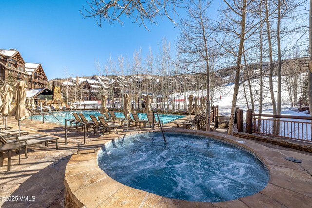 130 Daybreak Rd Unit R401, Beaver Creek, CO 81620 - snow covered pool with a community hot tub, a community pool, and a patio
