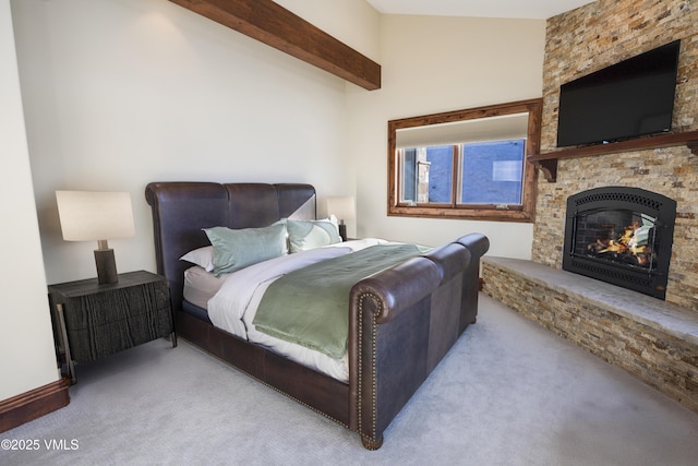 bedroom featuring vaulted ceiling with beams, light colored carpet, and a fireplace