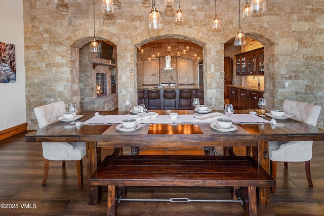 dining room with dark hardwood / wood-style floors and indoor wet bar