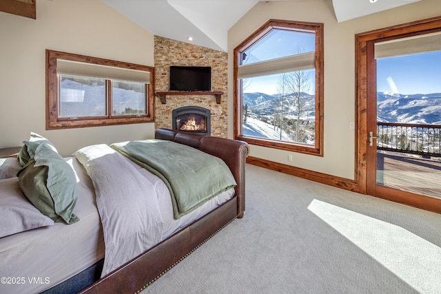 bedroom featuring light colored carpet, access to exterior, vaulted ceiling, and a fireplace