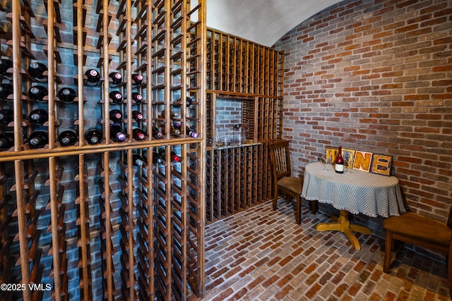 wine cellar with brick wall and vaulted ceiling