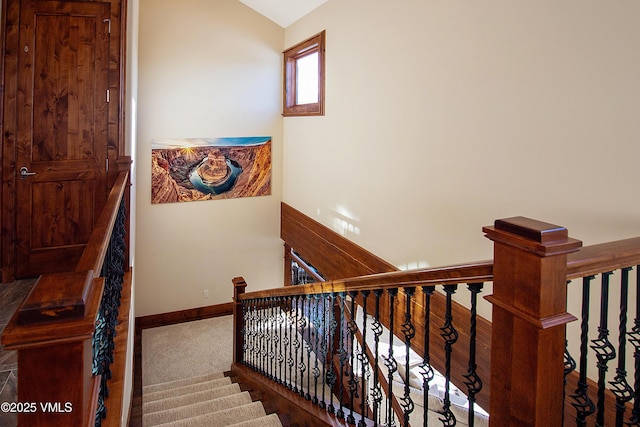 stairs with carpet floors and vaulted ceiling