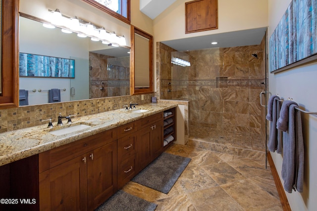 bathroom featuring tasteful backsplash, vanity, lofted ceiling, and an enclosed shower