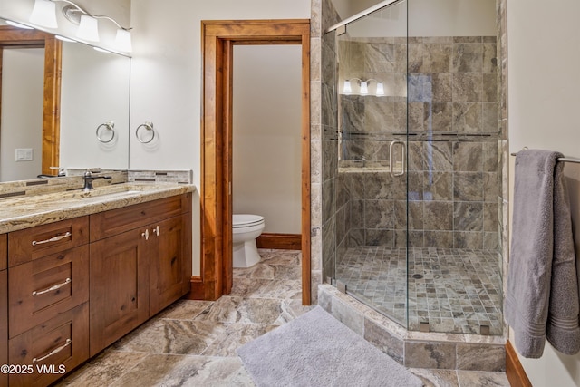 bathroom with walk in shower, vanity, and toilet