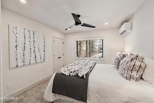 carpeted bedroom with a wall mounted air conditioner, recessed lighting, a closet, baseboards, and ceiling fan