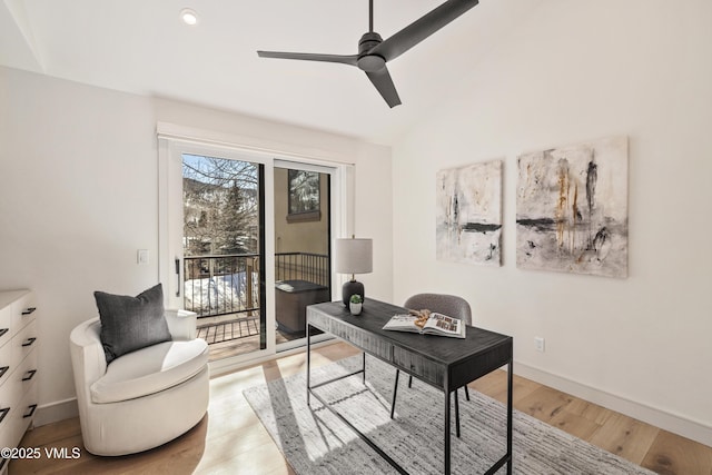 office space with light wood finished floors, baseboards, a ceiling fan, and vaulted ceiling