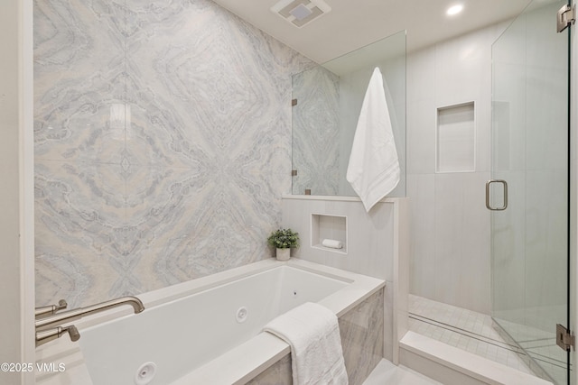 full bath with a shower stall, a jetted tub, and visible vents