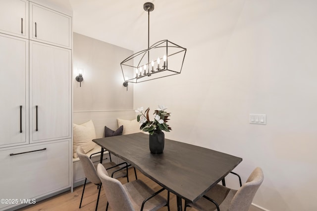 dining space with a chandelier and light wood-style flooring