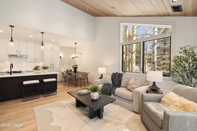 living room featuring visible vents, high vaulted ceiling, light wood-style flooring, recessed lighting, and wooden ceiling