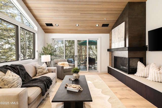 living room with visible vents, a healthy amount of sunlight, and wood ceiling