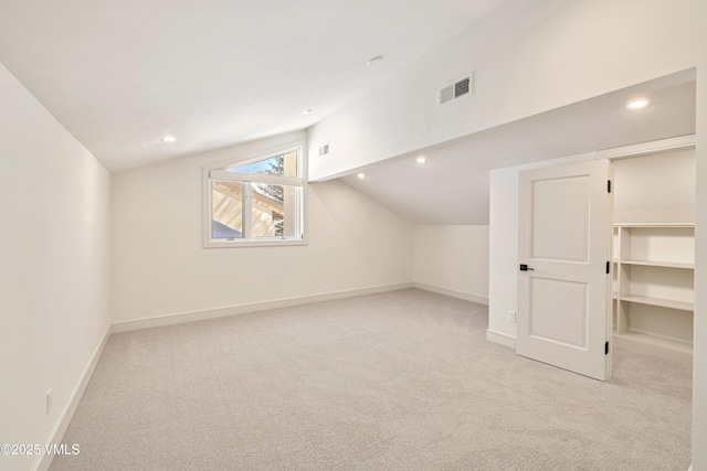 bonus room featuring visible vents, carpet floors, and vaulted ceiling