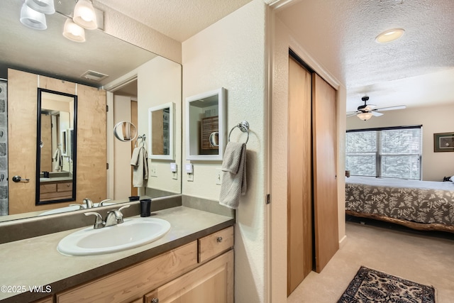 55 River Pines Ct Unit A204, Edwards, CO 81632 - ensuite bathroom featuring a textured ceiling, vanity, and a ceiling fan