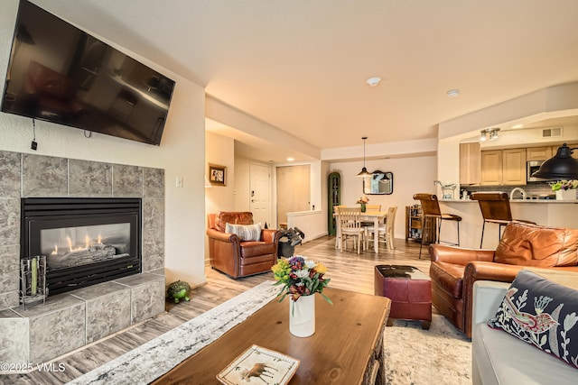 55 River Pines Ct Unit A204, Edwards, CO 81632 - living area featuring light wood-style floors, a tile fireplace, and recessed lighting