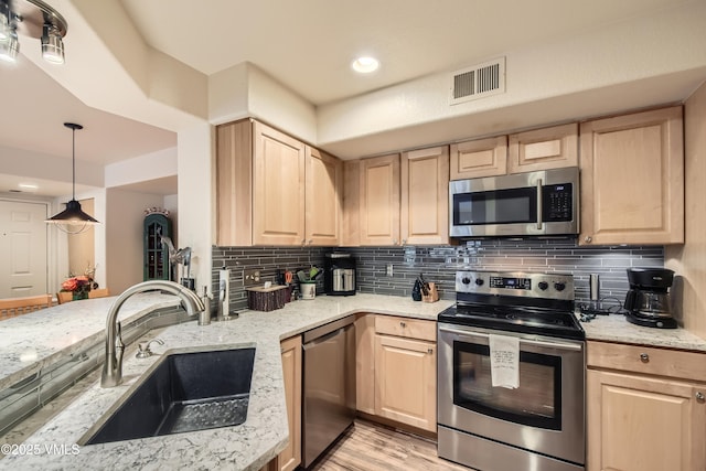 55 River Pines Ct Unit A204, Edwards, CO 81632 - kitchen featuring appliances with stainless steel finishes, light brown cabinetry, light stone countertops, and recessed lighting