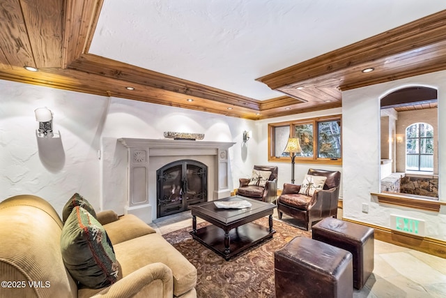 living room with ornamental molding, a raised ceiling, and wooden ceiling