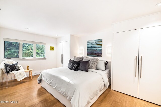 103 Willow Pl Unit 301, Vail, CO 81657 - bedroom with two closets, light wood-style floors, and recessed lighting