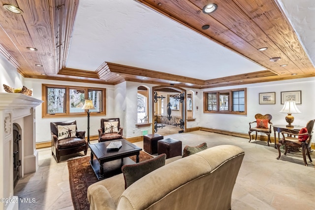 living room featuring wood ceiling, ornamental molding, a tray ceiling, and a wealth of natural light