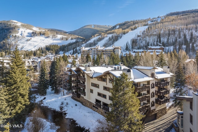 snowy aerial view featuring a mountain view