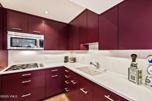 103 Willow Pl Unit 301, Vail, CO 81657 - kitchen with appliances with stainless steel finishes, red cabinetry, light countertops, and recessed lighting