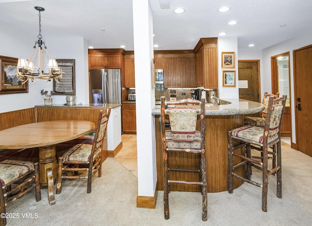 120 Offerson Rd Unit 6140, Beaver Creek, CO 81620 - kitchen featuring stainless steel appliances, light carpet, recessed lighting, a chandelier, and brown cabinetry
