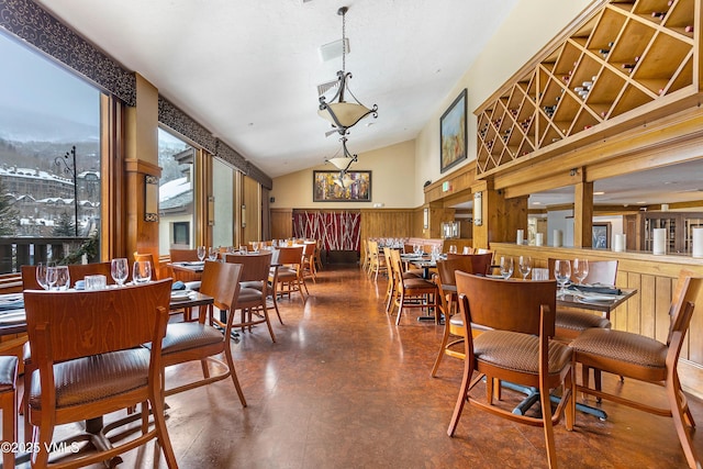 120 Offerson Rd Unit 6140, Beaver Creek, CO 81620 - dining room with finished concrete flooring, wainscoting, lofted ceiling, and wood walls