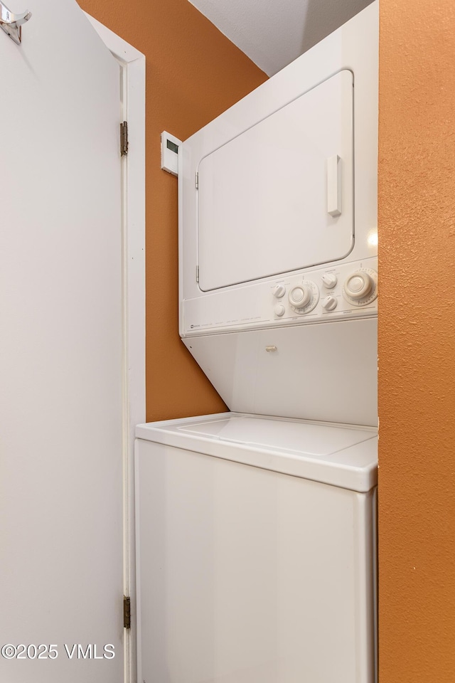 laundry area with laundry area and stacked washer and dryer