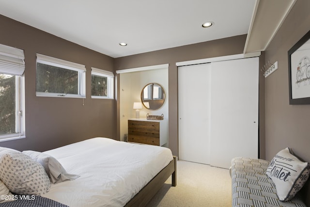 bedroom featuring recessed lighting, a closet, and carpet