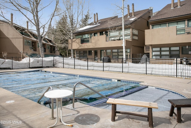 pool featuring a patio area and fence