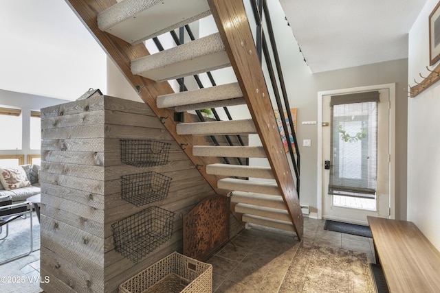 stairs featuring tile patterned floors and a healthy amount of sunlight