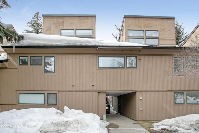 snow covered building with a carport