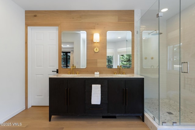 971 Winslow Rd, Edwards, CO 81632 - full bathroom featuring wood finished floors, a shower stall, double vanity, baseboards, and recessed lighting