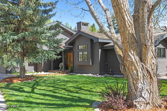 971 Winslow Rd, Edwards, CO 81632 - view of front facade with a front yard, a chimney, stucco siding, and a garage